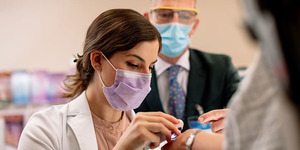 Mayo Clinic dermatology resident in Minnesota examining a patient