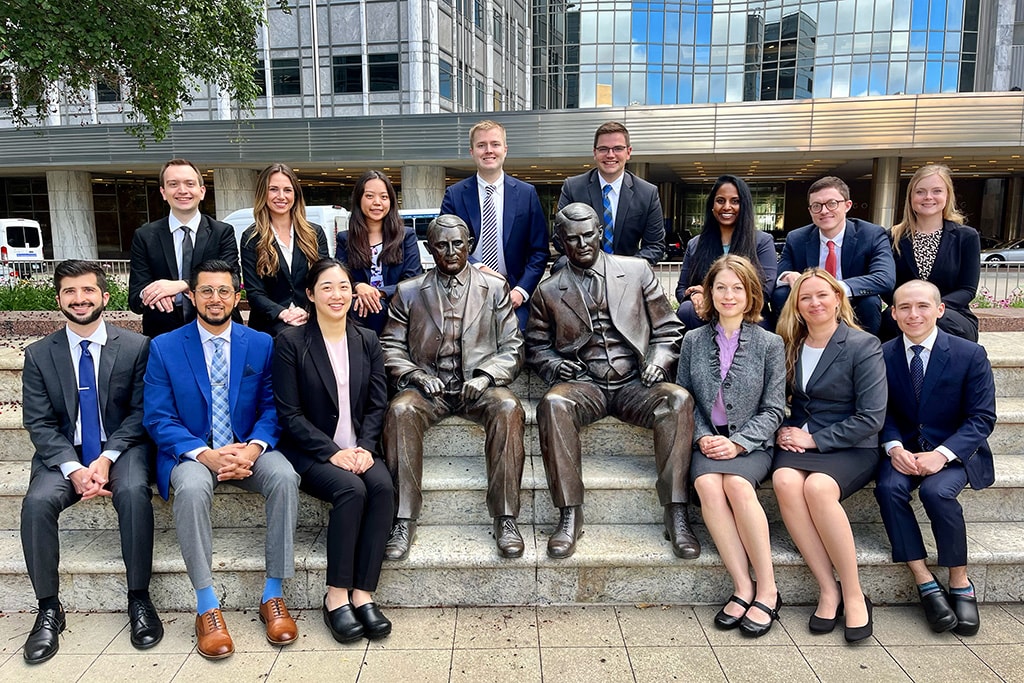 Fourteen people from the Diagnostic Radiology Residency in Rochester, Minnesota, sat around the Mayo brothers statue for a class of 2026 group photo.