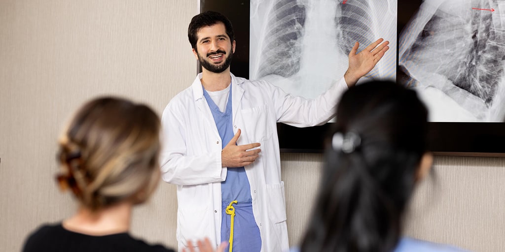 A faculty member from the Diagnostic Radiology Residency program in Rochester, Minnesota, stood in front of a classroom teaching trainees.