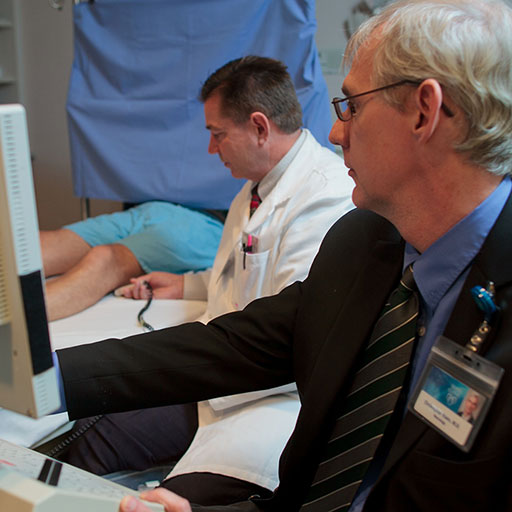 Physician performing an EMG test on a patient