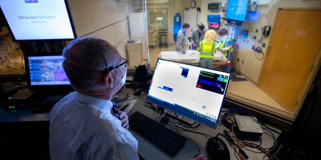 Physician watches a simulation from the simulation center control room at Mayo Clinic