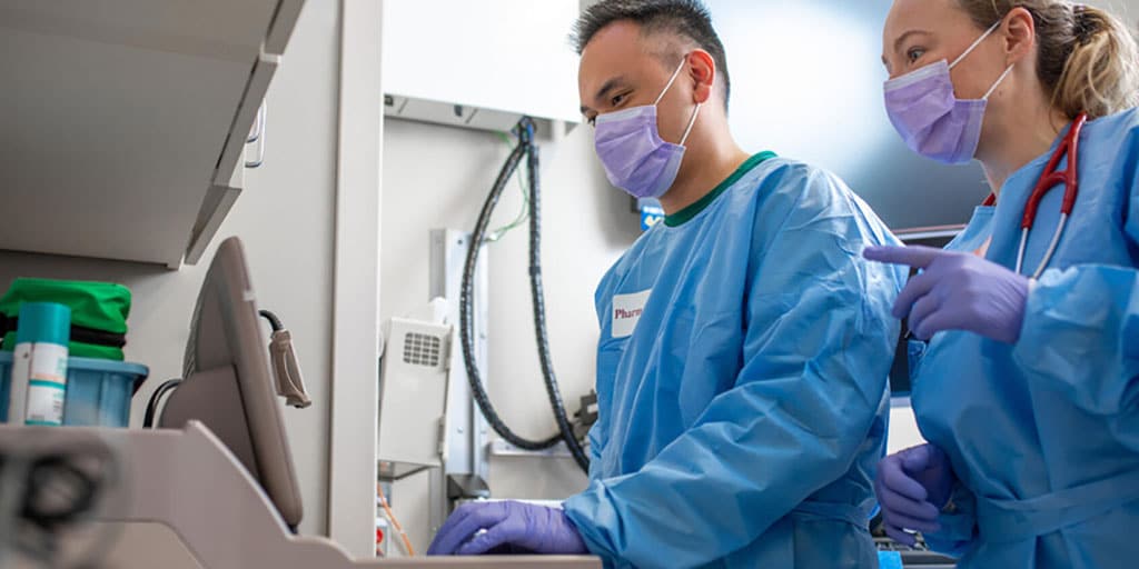 Emergency medicine residents researching on a computer