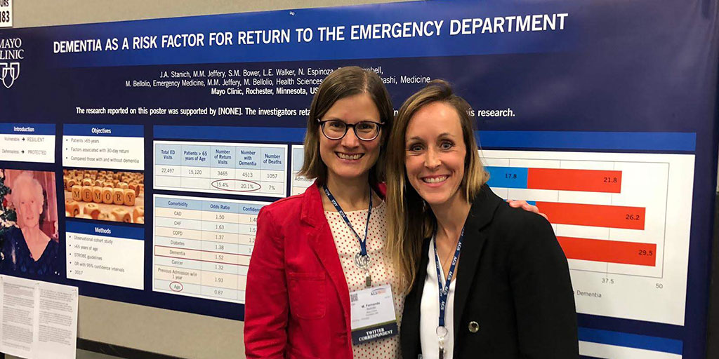 Residents present a research poster on dementia in the emergency department