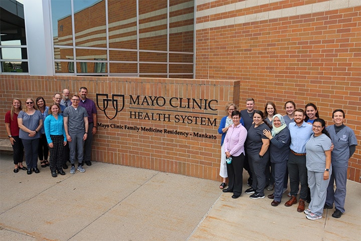 Family Medicine Residents stand by the new sign outside of the building at Mayo Clinic's campus in Mankato, Minnesota.