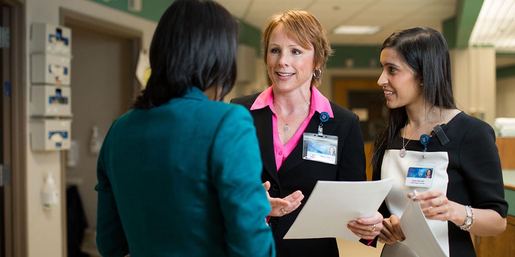 Transplant hepatologist Kymberly D. Watt, M.D., reviewing a patient chart with fellows.