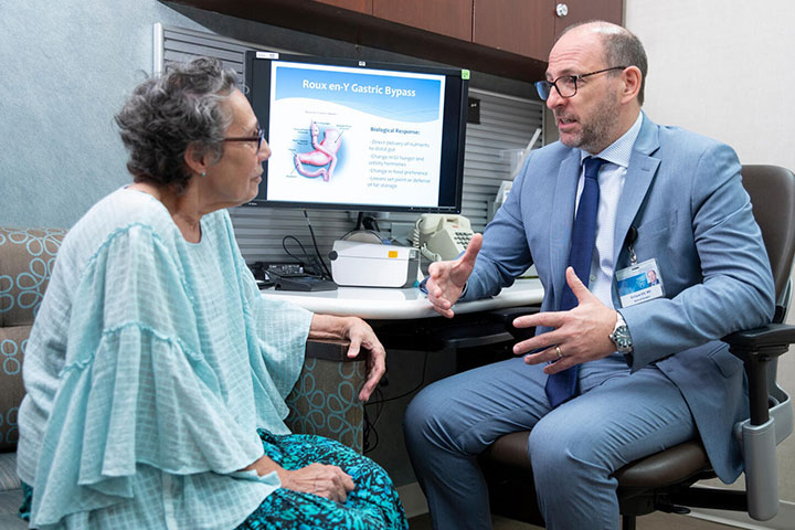 Enrique Elli, M.D. speaks with a patient at Mayo Clinic.