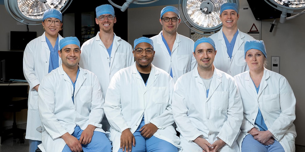 The 2023 General Surgery Chief Residents pose for a group photo in an operating room.