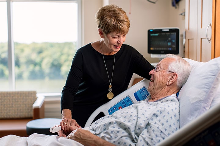 Geriatric physician chats with patient