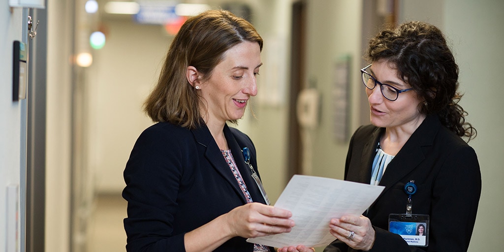 Geriatric Medicine Fellowship graduate, Dr. Bartley, speaks with a colleague at Mayo Clinic in Rochester, Minnesota.