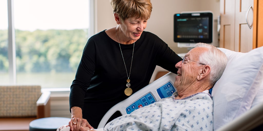 Geriatric physician chats with patient