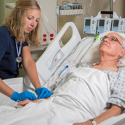 Hospital medicine fellow examines a patient in the hospital at Mayo Clinic