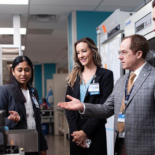 Infectious Diseases faculty and fellows speak in a laboratory at Mayo Clinic