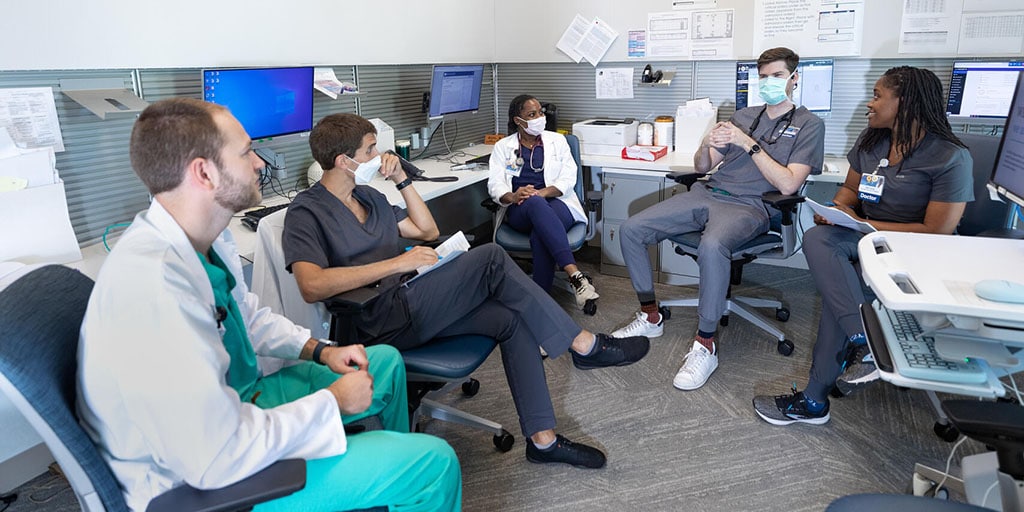 Internal medicine residents talk in a resident workroom at Mayo Clinic in Florida