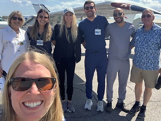 Internal Medicine residents posing for a group photo in front of an aircraft during their four-week Aerospace Medicine elective.