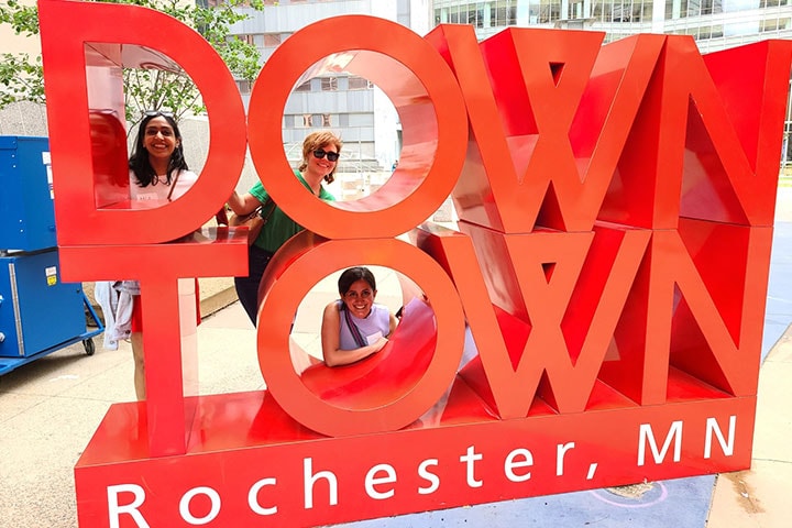 Residents take a photo with a downtown statue in Rochester, Minnesota