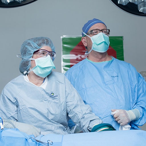 Surgeons in the operating room performing a colon/rectal surgery