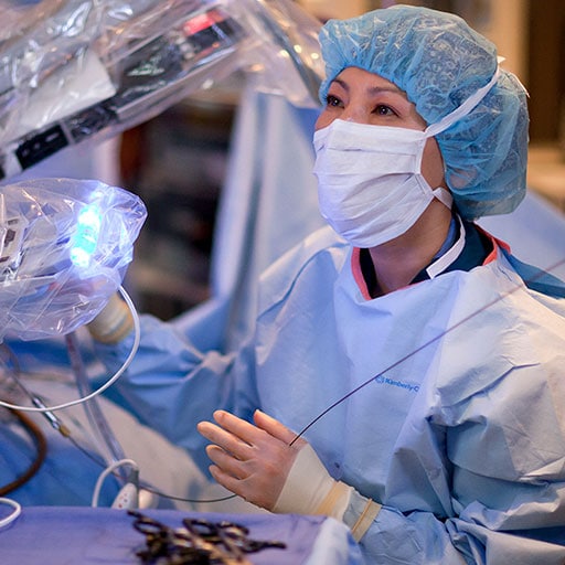 Surgeons conducting a minimally invasive surgery in the operating room