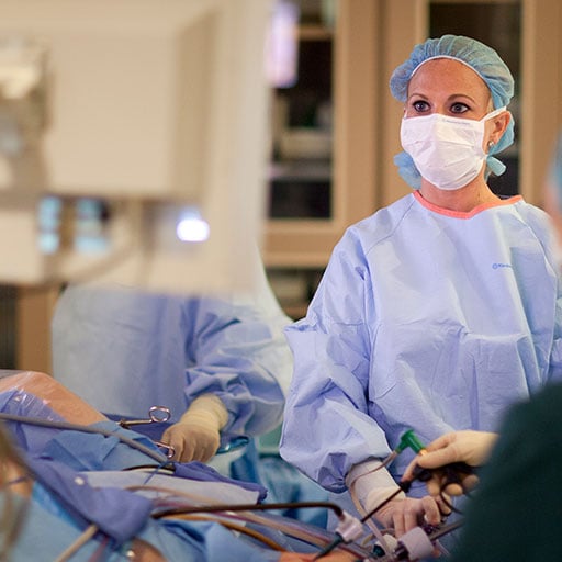 Surgeons conducting a minimally invasive surgery in the operating room