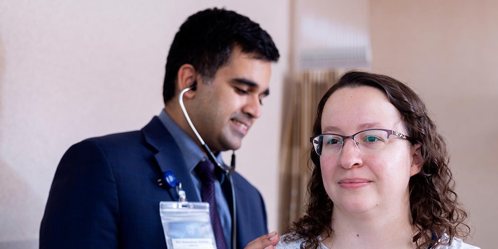 Sury Balakrishnan, MBBS, Nephrology fellow, examines a patient during a visit.