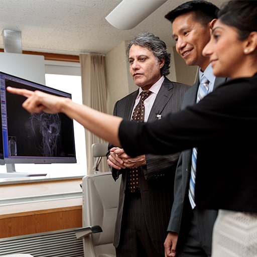 Neuro-Ophthalmology fellows discuss a scan together with a faculty member at Mayo Clinic in Rochester, Minnesota.