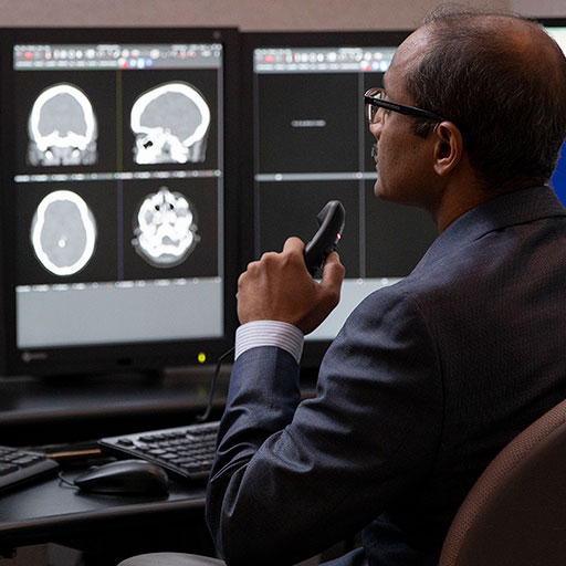 Neurologist examining brain scans on the computer