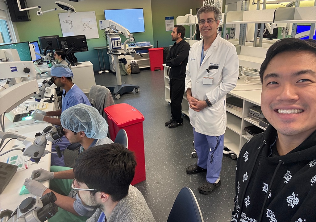 A faculty member works with medical students in a lab.