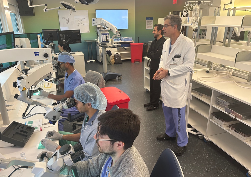 A faculty member works with medical students in a lab.