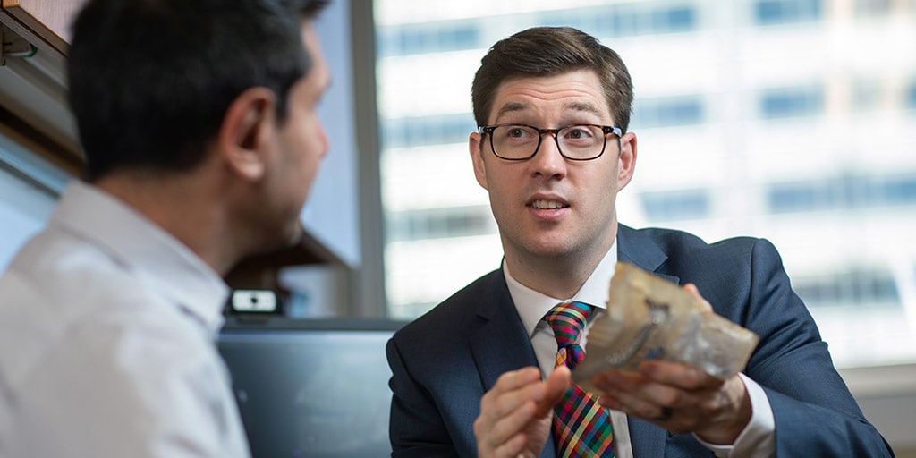 Mayo Clinic oral and maxillofacial surgeons examining a model