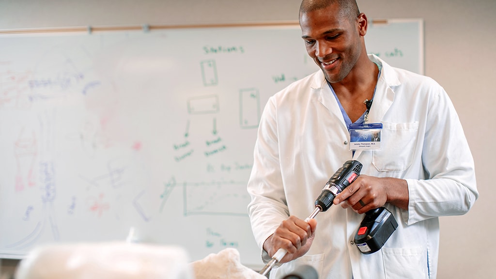 Orthopedic Surgery Residency trainee uses a drill in the classroom