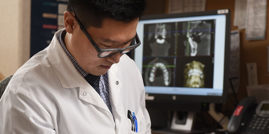 Mayo Clinic Periodontics resident reviewing a patient record.