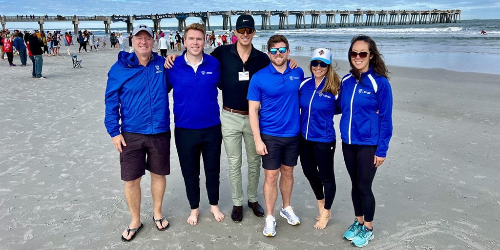 Primary Care Sports Medicine Fellowship faculty and fellow group photo at 2022 Super Girl Surf Pro Competition in Jacksonville Beach, Florida.