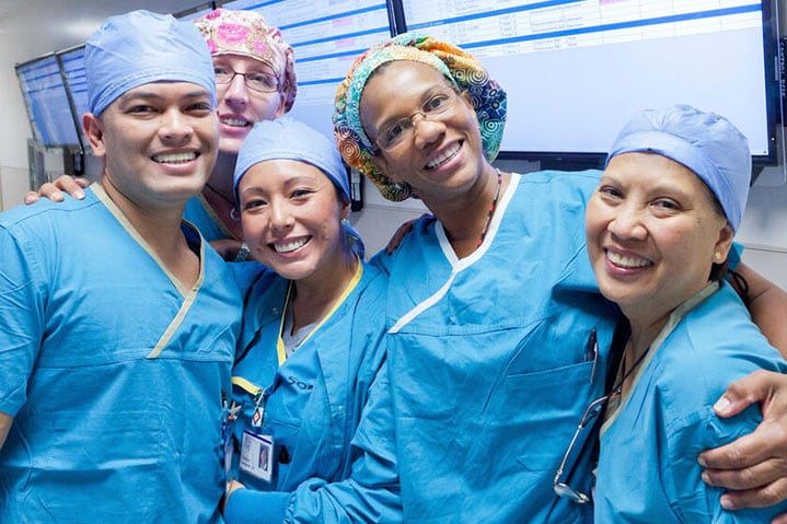 Group of nurses smiling for a picture in the hallways