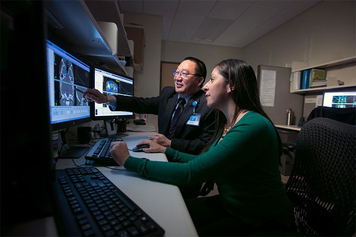 Two Radiation Oncology residents consulting at Mayo Clinic.