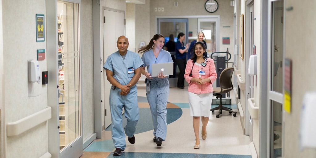 Renal Transplant Fellowship program director, Dr. Sumi Nair, walks down the hallway with renal and nephrology transplant fellows at Mayo Clinic in Phoenix, Arizona.