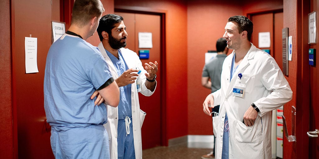 Mayo Clinic trainees talking in simulation center