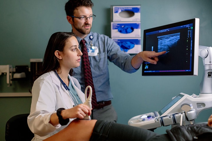 A doctor working with a fellow in the Rheumatology Fellowship at Mayo Clinic in Phoenix, Arizona, doing an ultrasound for a patient.