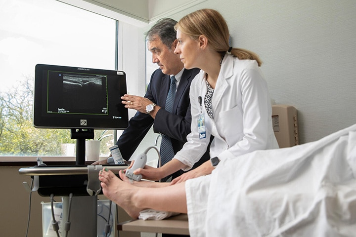 A consultant and resident from the Rheumatology Fellowship in Jacksonville, Florida, view an ultrasound.