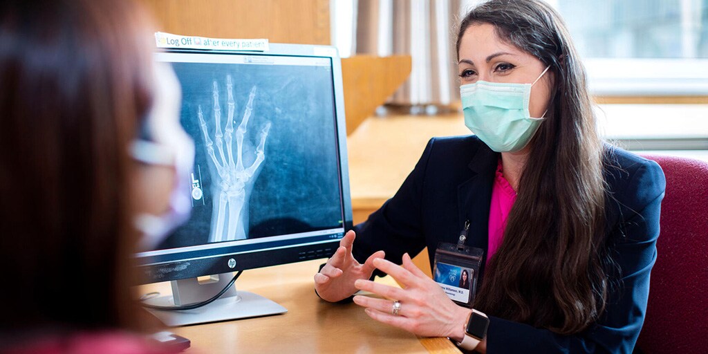 A fellow at Mayo Clinic's Rheumatology Fellowship program in Rochester, Minnesota, has a discussion with a patient.