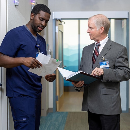 A Mayo Clinic nurse practitioner and physician speak in hallway