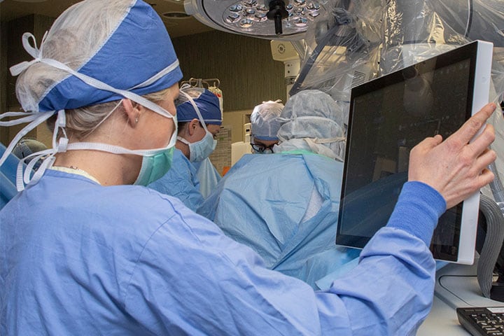 Spine Surgery fellow working on a computer in the OR at Mayo Clinic in Rochester, Minnesota.