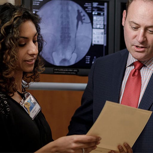Urology faculty Aqsa Khan, M.D., and Mitchell Humphreys, M.D., discuss a patient record at Mayo Clinic in Arizona.