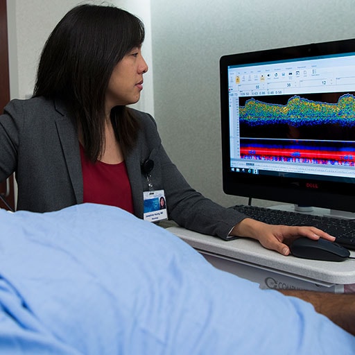 Dr. Josephine Huang performing a transcrainial doppler ultrasound on a patient