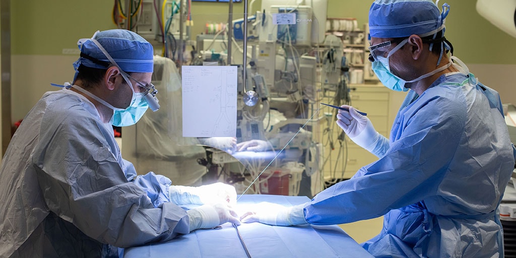 Mayo Clinic vascular surgery fellow and surgeon in the operating room