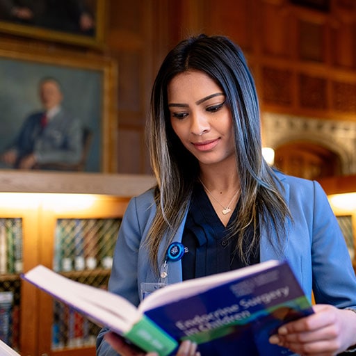 Student reading book in Plummer Library