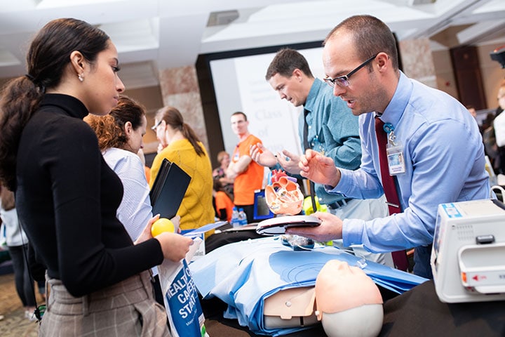 Mayo Clinic faculty member and prospective students at an open house event