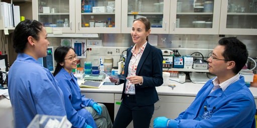 A Mayo Clinic researcher engages with learners in the laboratory