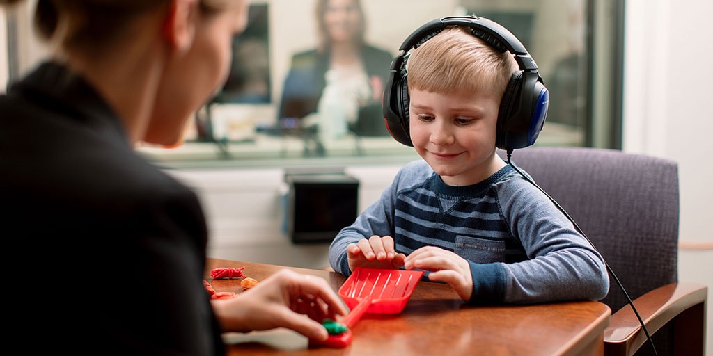 Mayo Clinic audiologist conducting a hearing test on a child