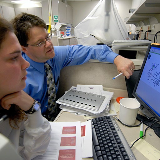 Mayo Clinic cytogenetic technologists working on a computer
