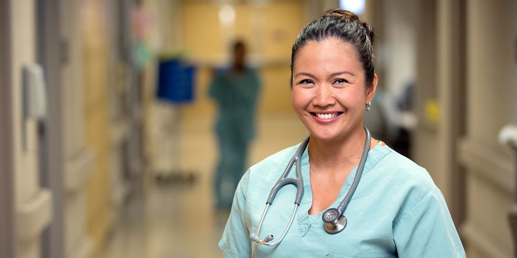 Mayo Clinic nurse smiling in a hospital hallway